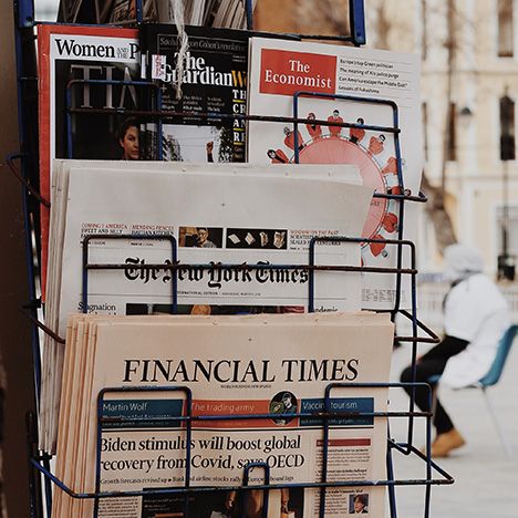 Newspapers in a rack for sale